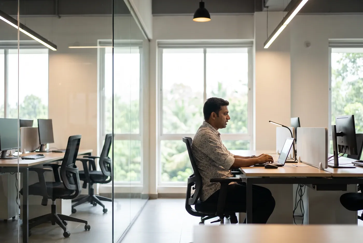 A sales rep at a desk speaking toward their own screen